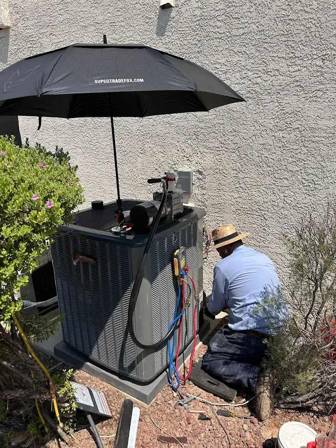 HVAC technician performing outdoor AC maintenance in Pompano Beach